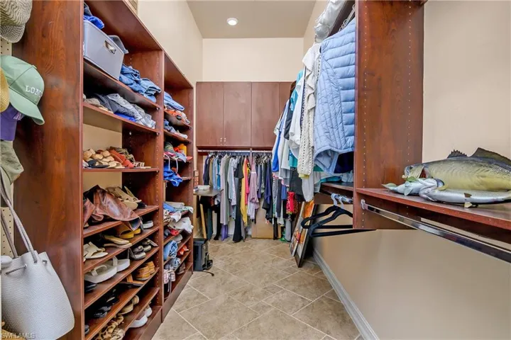 Walk in closet with light tile patterned flooring