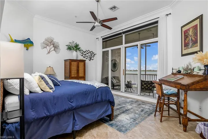 Bedroom with access to outside, ornamental molding, light tile patterned floors, and ceiling fan