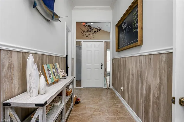 Entrance foyer with light tile patterned floors