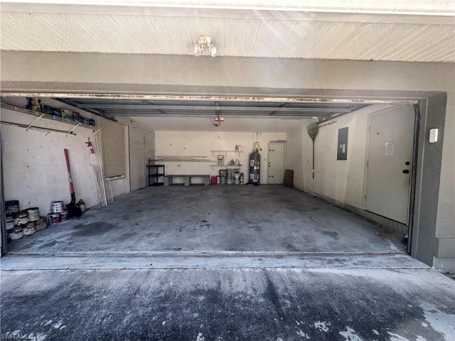 2 Car Garage with a garage door opener, electric panel, and electric water heater