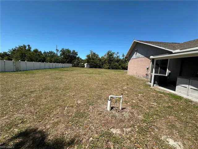 View from Double Gates of Left Side of the Yard with Vinyl Fence