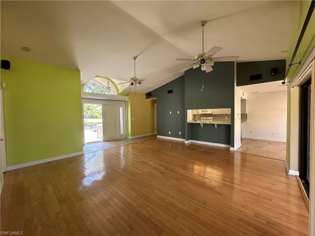 Extremely Spacious Living Area Looking Out the Front Double Solid Doors. And a Peak of the Kitchen Area.