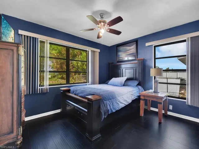 Bedroom with ceiling fan and dark hardwood / wood-style flooring
