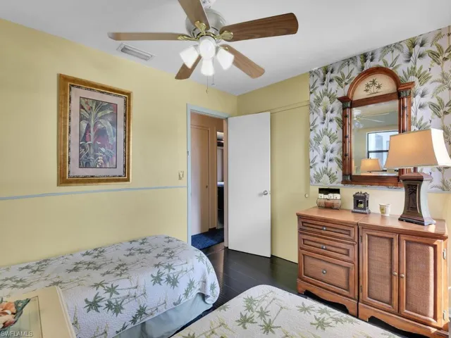 Bedroom with dark hardwood / wood-style flooring and ceiling fan