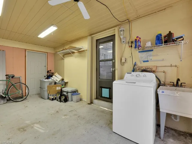 Laundry area featuring washer / dryer, ceiling fan, and sink