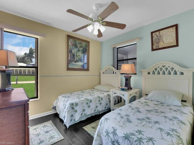 Bedroom with dark wood-type flooring and ceiling fan