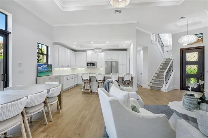 Living room with raised ceiling, new lighting and porcelain wood look tile floors,
