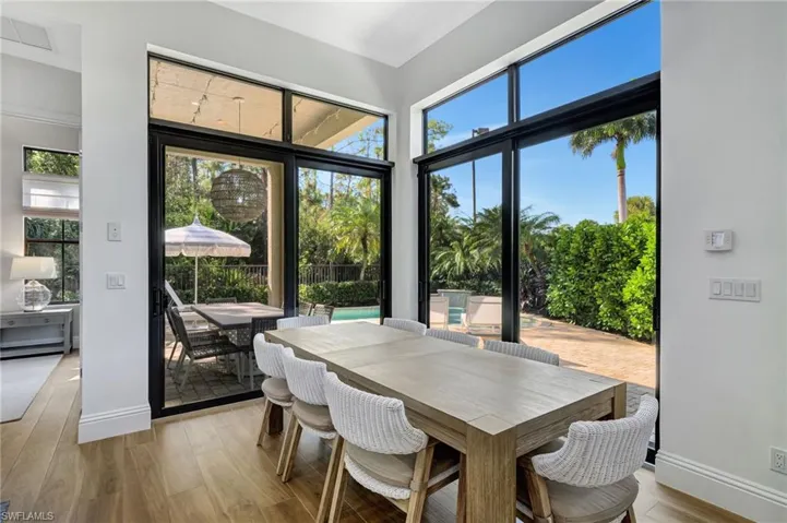 Dining room with oversized impact glass sliding doors for amazing view of backyard pool and preserve