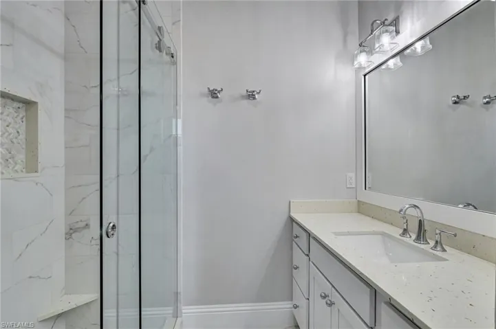 Remodeled Second floor Jack & Jill Bathroom featuring a tile shower and vanity with quartz countertop