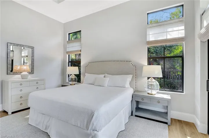 Master Bedroom with porcelain wood look tile flooring, remote control blinds and ceiling fan