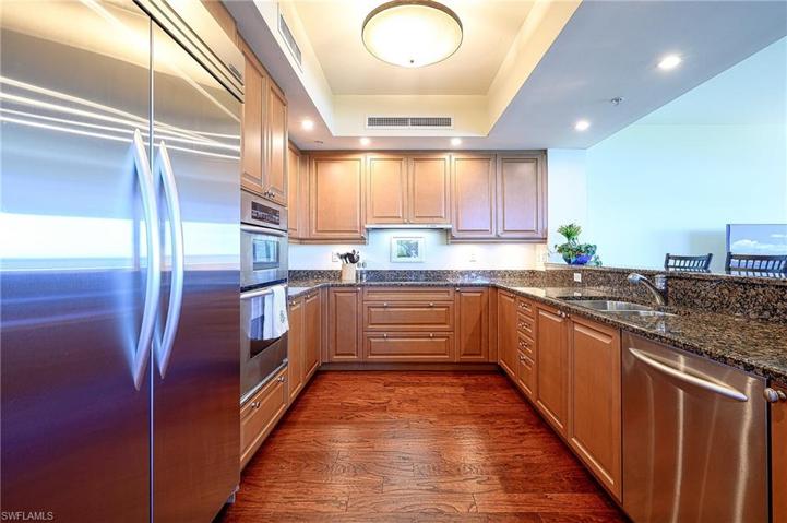 Granite countertops, lots of cabinetry and wood floors