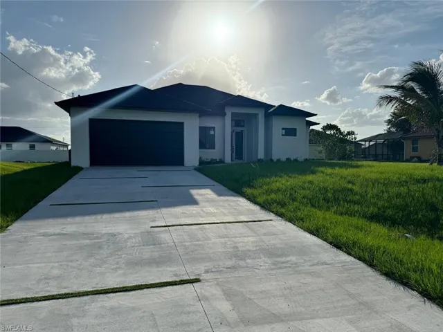 Ranch-style house with a garage and a front yard