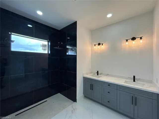 Bathroom featuring tile patterned flooring and double sink vanity