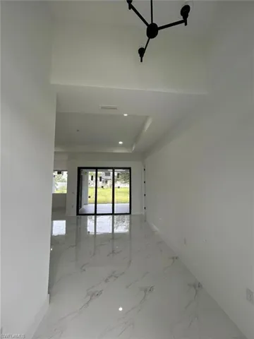 Spare room with tile patterned flooring and a tray ceiling