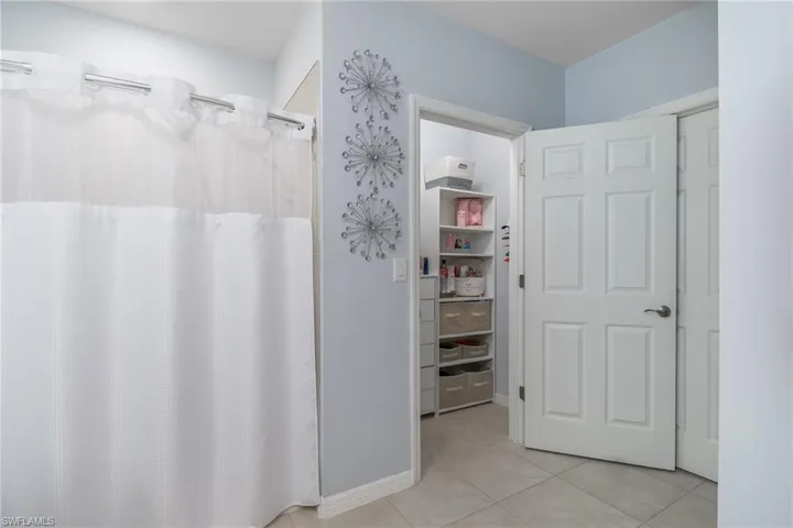 Bathroom featuring tile patterned floors and curtained shower