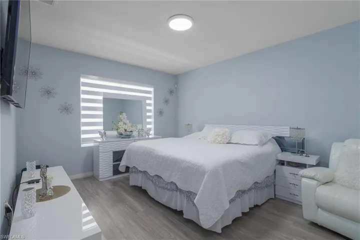 Bedroom featuring wood finished floors and baseboards