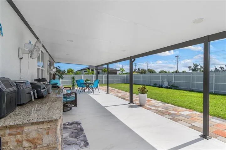 Fenced backyard with outdoor dining area and a patio