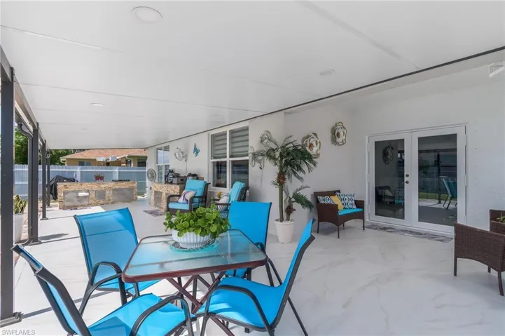 View of patio / terrace featuring french doors, outdoor dining space, and an outdoor kitchen