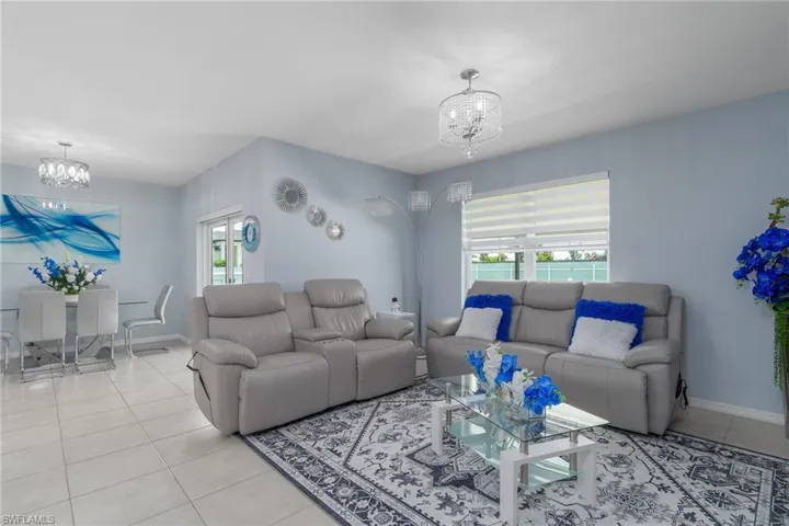Living room featuring a chandelier and light tile patterned floors