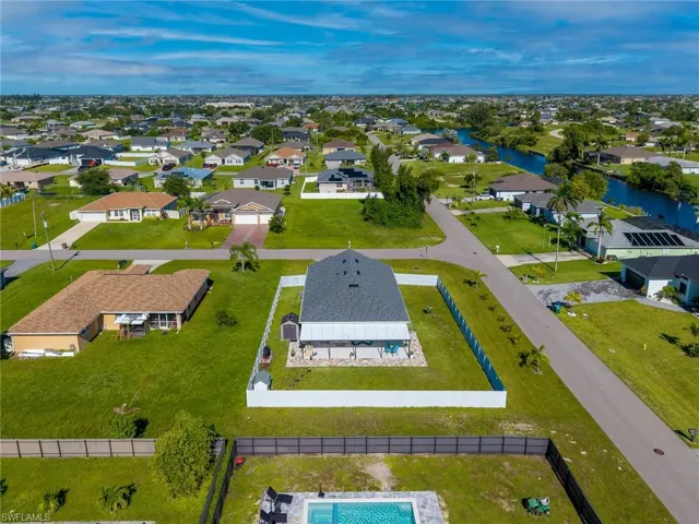 Aerial perspective of suburban area with a nearby body of water