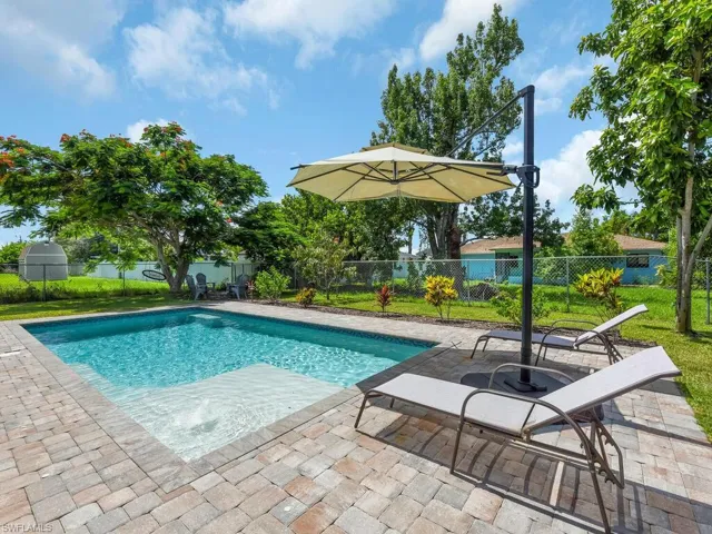 View of swimming pool with a patio and a fenced backyard