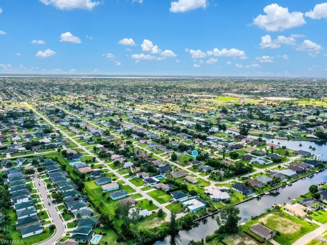 Aerial view of property's location with nearby suburban area and a large body of water