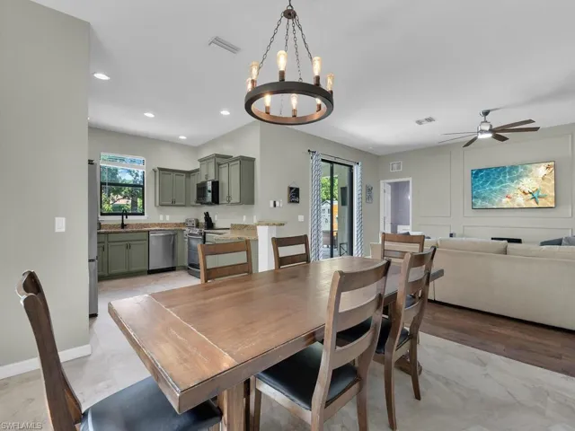 Dining room with a chandelier, ceiling fan, and recessed lighting