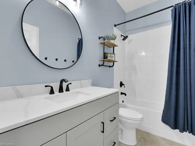 Bathroom featuring shower / bath combo, vanity, and tile patterned floors
