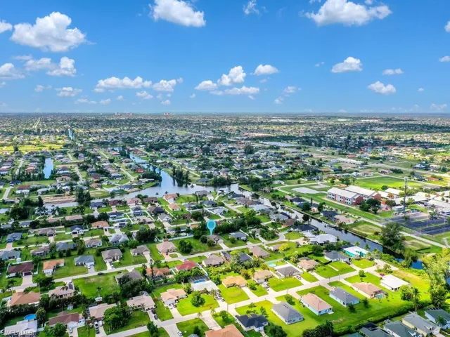 Aerial view of property's location with nearby suburban area and a large body of water