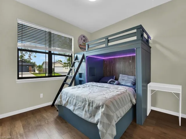 Bedroom with baseboards and wood finished floors