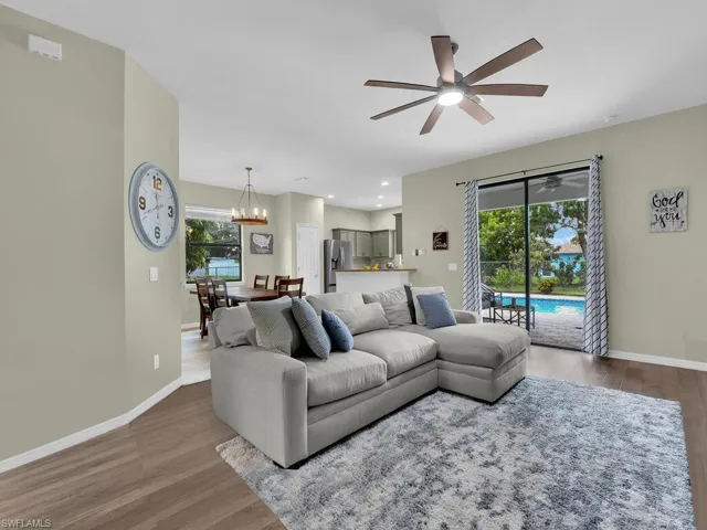 Living area featuring a ceiling fan, wood finished floors, plenty of natural light, a chandelier, and recessed lighting