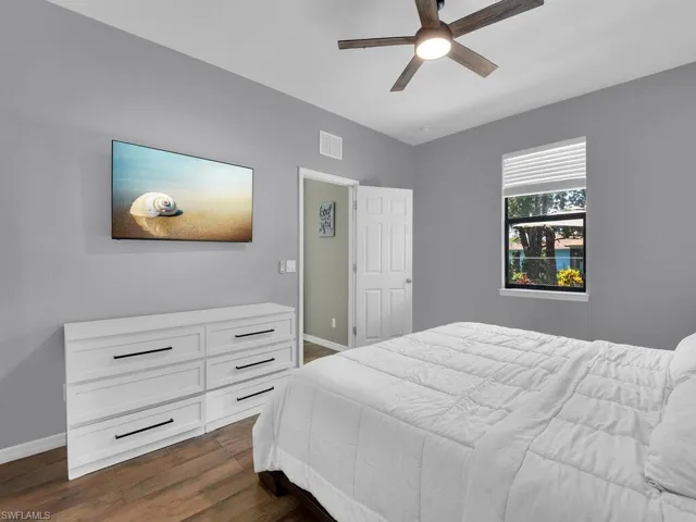 Bedroom featuring dark wood-style floors and a ceiling fan