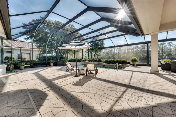 View of patio / terrace featuring a lanai