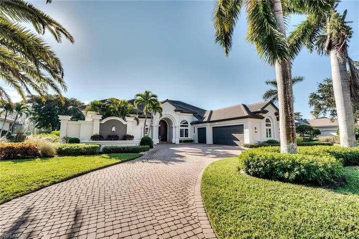 Mediterranean / spanish-style home with a garage and a front yard