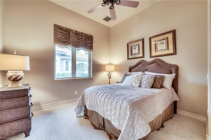 Bedroom featuring light colored carpet and ceiling fan