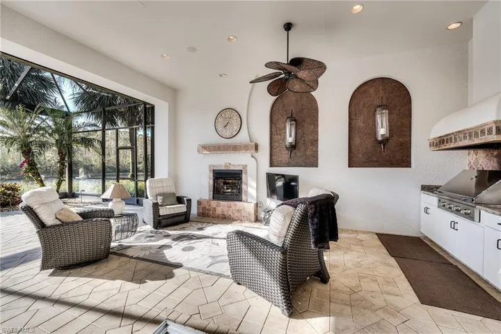 Living room with a tile fireplace and ceiling fan
