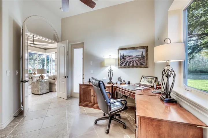 Office space with ceiling fan, a healthy amount of sunlight, and light tile patterned floors