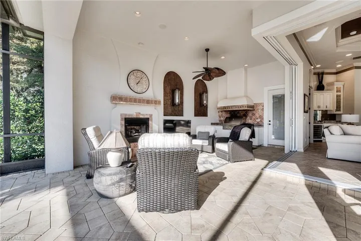 View of patio featuring an outdoor living space with a fireplace and ceiling fan