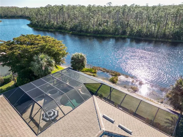 Birds eye view of property with a water view