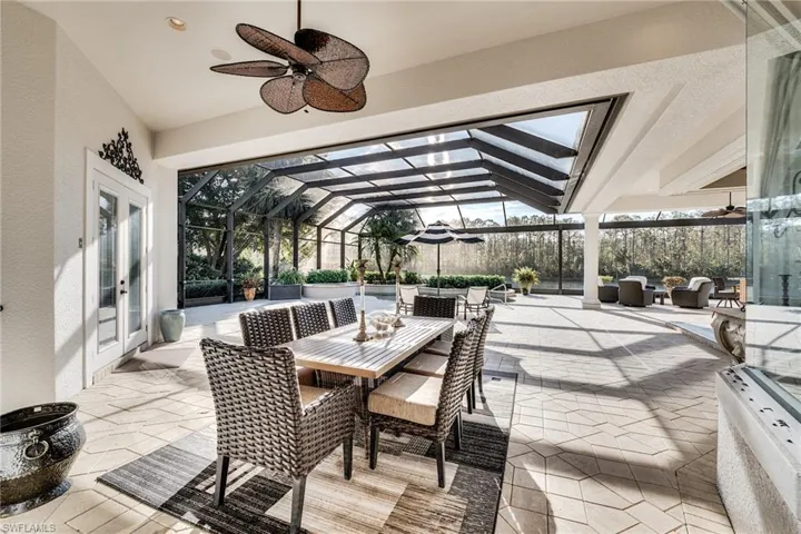 View of patio / terrace featuring an outdoor hangout area, ceiling fan, and glass enclosure