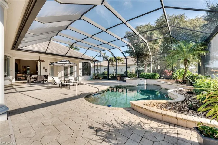 View of pool featuring a lanai, a patio, and ceiling fan