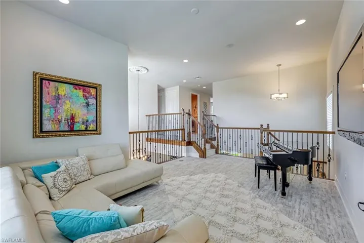 Sitting room with recessed lighting, an upstairs landing, carpet floors, and a chandelier