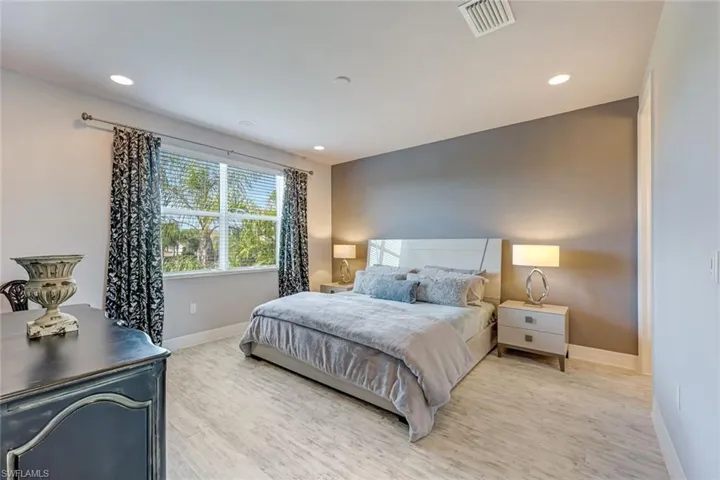 Bedroom with light wood-type flooring and recessed lighting
