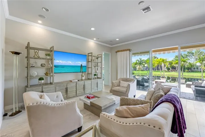 Living room with ornamental molding and recessed lighting