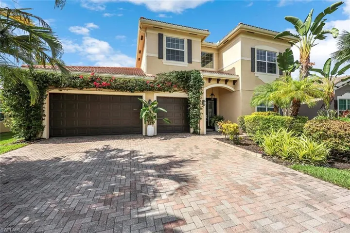 Mediterranean / spanish home with stucco siding, a garage, decorative driveway, and a tiled roof