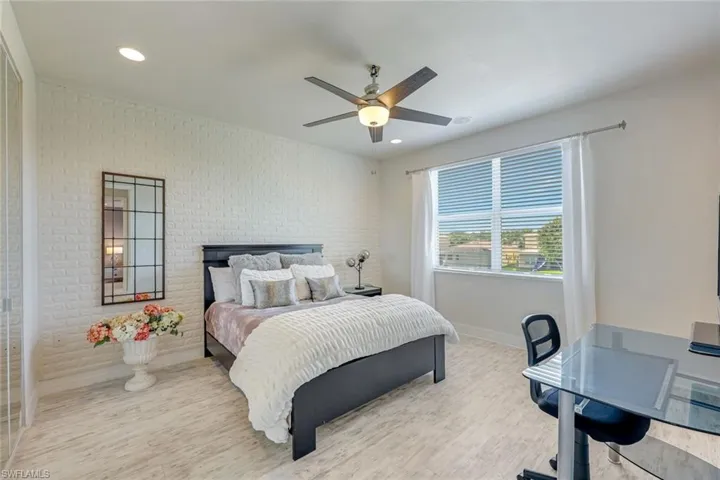 Bedroom featuring light wood-style floors, ceiling fan, and recessed lighting