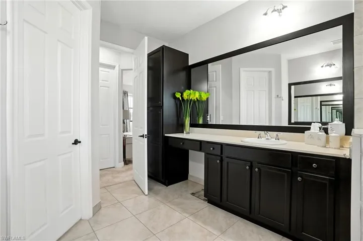 Bathroom featuring light tile patterned floors and vanity