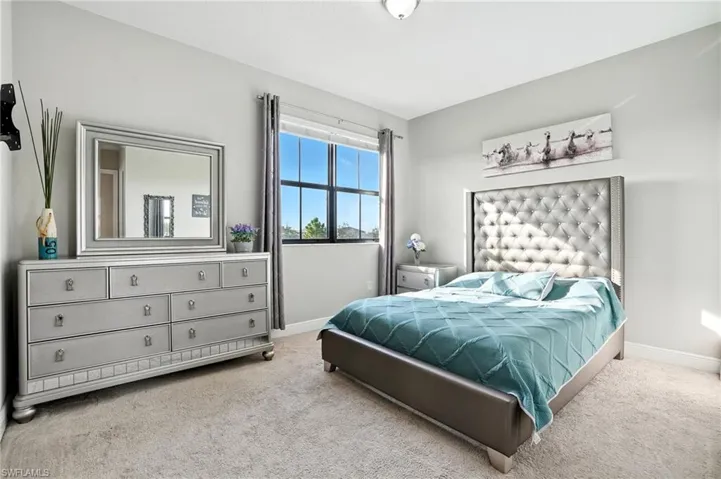Carpeted bedroom with baseboards