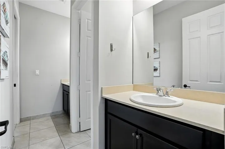 Bathroom with vanity and light tile patterned floors