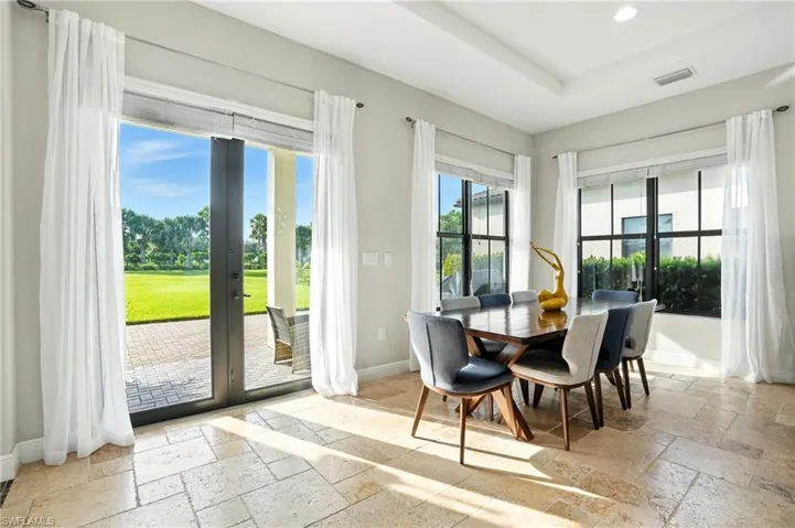 Dining area featuring stone tile floors, french doors, and recessed lighting